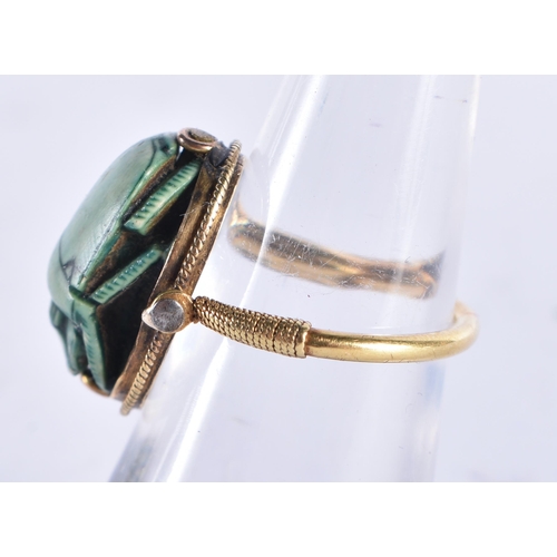 296 - AN EARLY EGYPTIAN FAIENCE SCARAB BEETLE RING the reverse carved with figures and a boat. Beetle 1.75... 