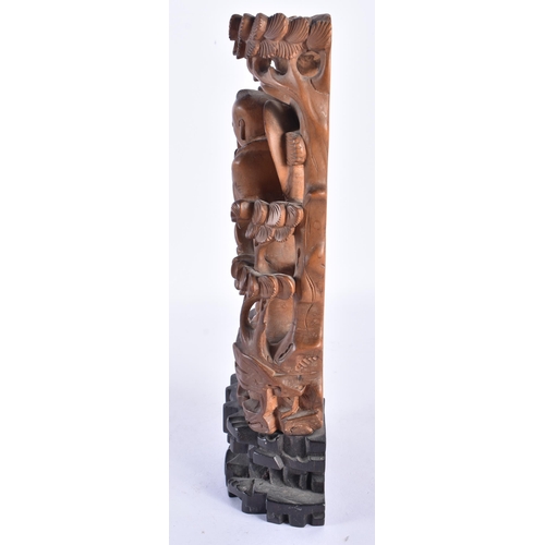 355 - AN 18TH/19TH CENTURY CHINESE CARVED HARDWOOD FIGURE upon a stand possibly zitan wood. 23.5 cm high.