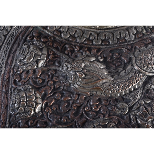 367 - A LARGE 19TH CENTURY TIBETAN REPOUSSE DRAGON HORN decorated in relief with foliage. 34 cm wide.