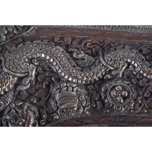 367 - A LARGE 19TH CENTURY TIBETAN REPOUSSE DRAGON HORN decorated in relief with foliage. 34 cm wide.