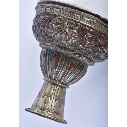 367 - A LARGE 19TH CENTURY TIBETAN REPOUSSE DRAGON HORN decorated in relief with foliage. 34 cm wide.