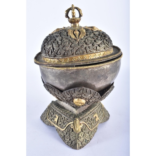 372 - AN 18TH/19TH CENTURY TIBETAN MIXED METAL REPOUSSE BOX AND COVER decorated with buddhistic emblems. 1... 