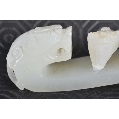 383 - AN 18TH CENTURY GREENISH WHITE JADE BELT HOOK Qing. 12.5 cm long.