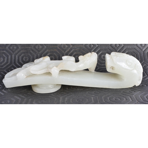 383 - AN 18TH CENTURY GREENISH WHITE JADE BELT HOOK Qing. 12.5 cm long.