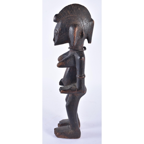 415 - AN AFRICAN SENUFO CARVED WOOD TRIBAL FIGURE Ivory Coast. 34 cm high.