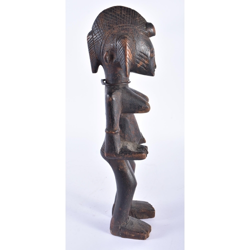 415 - AN AFRICAN SENUFO CARVED WOOD TRIBAL FIGURE Ivory Coast. 34 cm high.