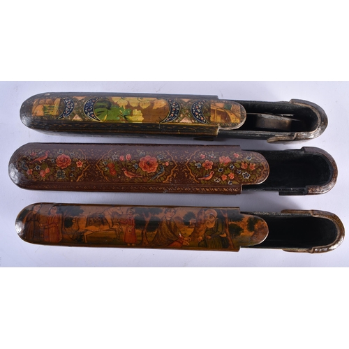 418 - THREE 19TH CENTURY MIDDLE EASTERN PERSIAN QAJAR LACQUER PEN CASES. 24 cm long. (3)