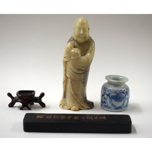 458 - A CHINESE QING DYNASTY SOAPSTONE IMMORTAL together with an ink cake etc. Largest 14 cm high. (4)