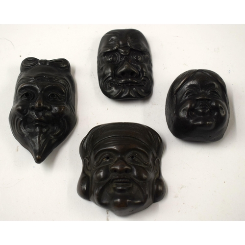 486 - FOUR 19TH CENTURY JAPANESE MEIJI PERIOD BRONZE MASK NETSUKES. Largest 7 cm x 5 cm. (4)