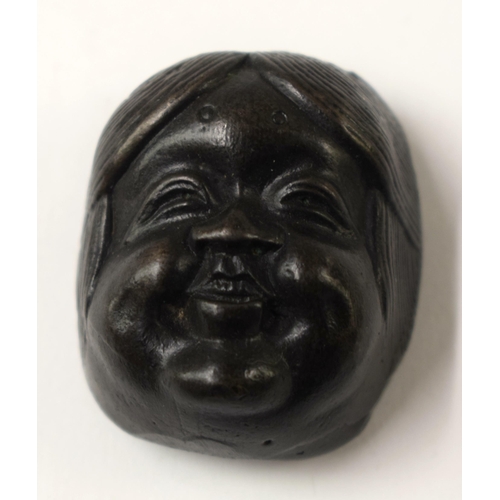 486 - FOUR 19TH CENTURY JAPANESE MEIJI PERIOD BRONZE MASK NETSUKES. Largest 7 cm x 5 cm. (4)