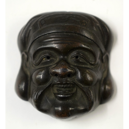 486 - FOUR 19TH CENTURY JAPANESE MEIJI PERIOD BRONZE MASK NETSUKES. Largest 7 cm x 5 cm. (4)