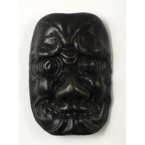 486 - FOUR 19TH CENTURY JAPANESE MEIJI PERIOD BRONZE MASK NETSUKES. Largest 7 cm x 5 cm. (4)