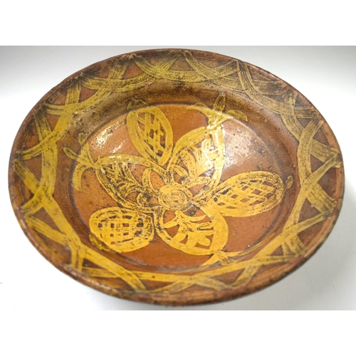 490 - AN 18TH CENTURY ENGLISH SLIPWARE POTTERY BOWL. 27 cm diameter.