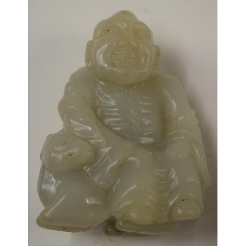 492 - A 19TH CENTURY CHINESE CARVED SOAPSTONE MOUNTAIN BOULDER Qing, together with a jade man. Largest 10 ... 