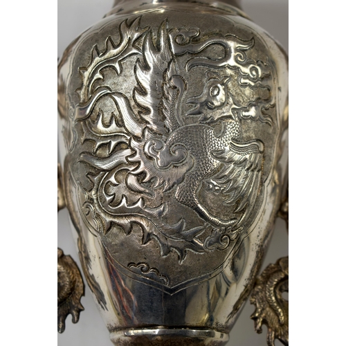 495 - A 19TH CENTURY CHINESE WHITE METAL TWIN HANDLED DRAGON VASE Late Qing. 32 cm x 18 cm.