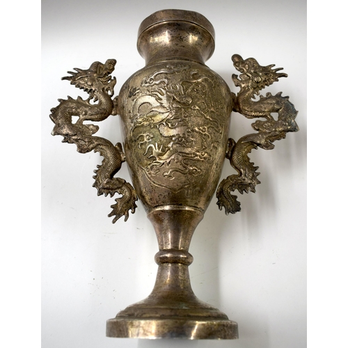 495 - A 19TH CENTURY CHINESE WHITE METAL TWIN HANDLED DRAGON VASE Late Qing. 32 cm x 18 cm.