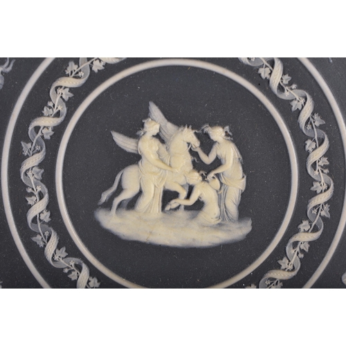 524 - A RARE LARGE 18TH/19TH CENTURY WEDGWOOD BLACK JASPERWARE POTTERY PLAQUE decorated with classical sce... 