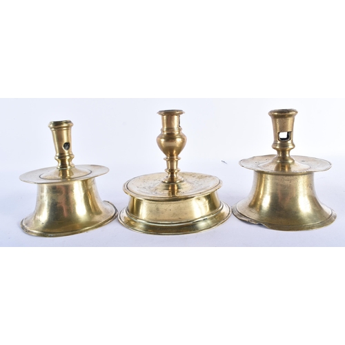 535 - A GROUP OF THREE 17TH CENTURY BRASS CAPSTAN CANDLESTICKS with tapered sockets and candle stub ejecto... 