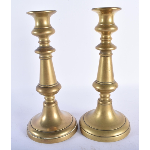 537 - TWO 18TH CENTURY BRASS CHAMBERSTICKS together with a pair of brass candlesticks. Largest 22.5 cm hig... 