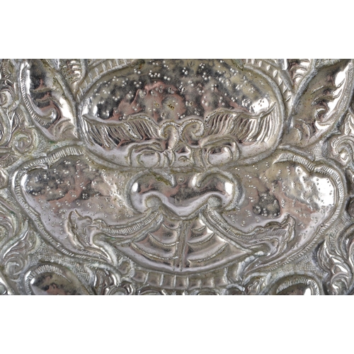 562 - A RARE LARGE 19TH CENTURY TIBETAN SILVER REPOUSSE CHARGER decorated with buddhistic emblems. 690 gra... 