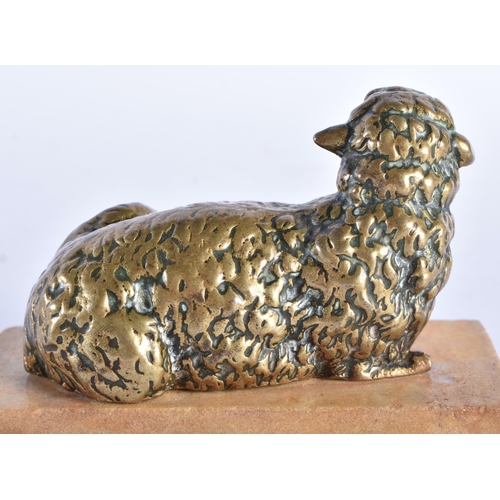 567 - AN 18TH CENTURY EUROPEAN BRONZE FIGURE OF A RECUMBENT LAMB modelled upon a stone base. 9.5 cm wide.