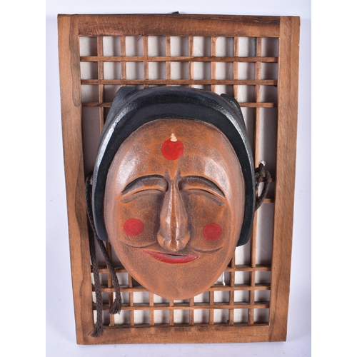 580 - AN UNUSUAL KOREAN CARVED AND PAINTED WOOD MASK PANEL together with a Chinese doll. Largest 36 cm x 2... 