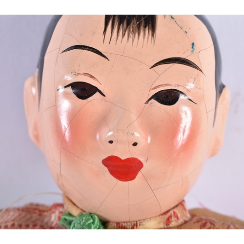 580 - AN UNUSUAL KOREAN CARVED AND PAINTED WOOD MASK PANEL together with a Chinese doll. Largest 36 cm x 2... 