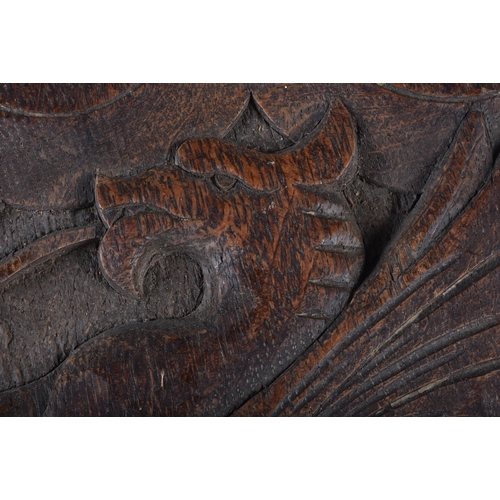 588 - A PAIR OF ARTS AND CRAFTS CARVED OAK DRAGON BELLOWS. 68 cm long.