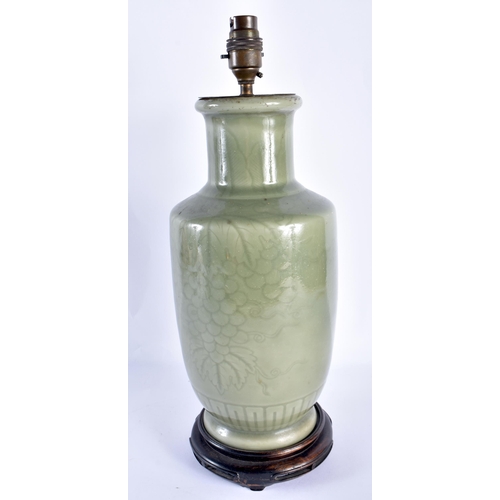 78 - A LOVELY CHINESE QING DYNASTY CELADON COUNTRY HOUSE LAMP incised with berries and vines. 42 cm high.