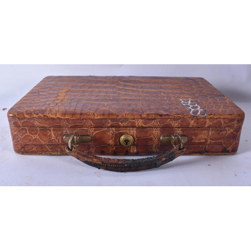 80 - AN ANTIQUE ENGLISH CROCODILE SKIN JEWELLERY BOX together with three leather cases & a cased gaming s... 