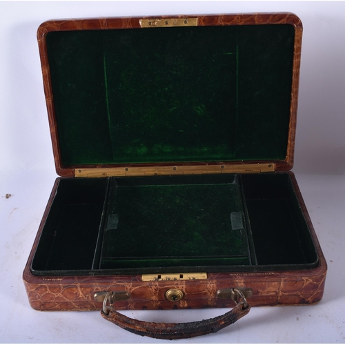 80 - AN ANTIQUE ENGLISH CROCODILE SKIN JEWELLERY BOX together with three leather cases & a cased gaming s... 