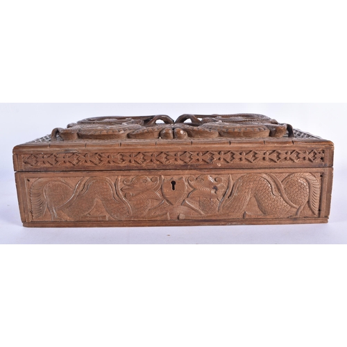 81 - A LATE 19TH CENTURY SOUTHEAST ASIAN CARVED WOOD DRAGON CASKET decorated with motifs. 30 cm x 20 cm.