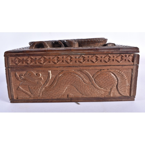 81 - A LATE 19TH CENTURY SOUTHEAST ASIAN CARVED WOOD DRAGON CASKET decorated with motifs. 30 cm x 20 cm.