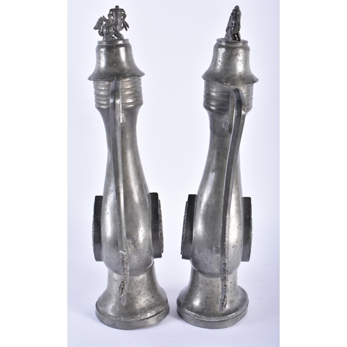 1005 - AN UNUSUAL PAIR OF 19TH CENTURY CHINESE PEWTER EWERS Qing, decorated with a buddhistic emblem. 34 cm... 