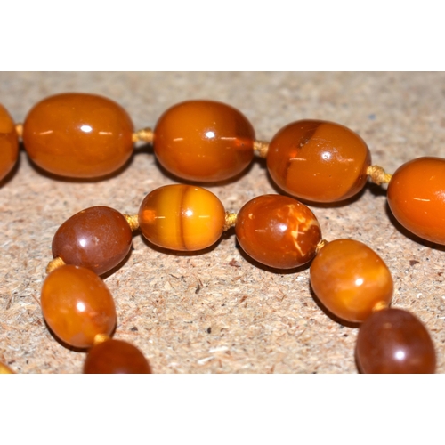 1105 - Antique Amber graduated necklace individually knotted.  86cm long, weight 57g, largest bead 17.6mm