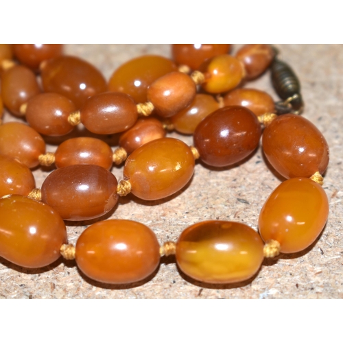 1105 - Antique Amber graduated necklace individually knotted.  86cm long, weight 57g, largest bead 17.6mm