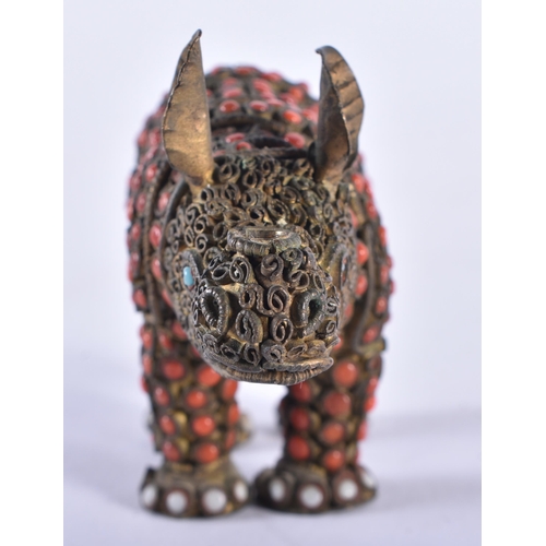 610 - AN ANTIQUE TIBETAN BRASS AND CORAL RHINOCEROS. 8 cm wide.