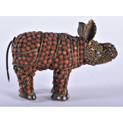 610 - AN ANTIQUE TIBETAN BRASS AND CORAL RHINOCEROS. 8 cm wide.