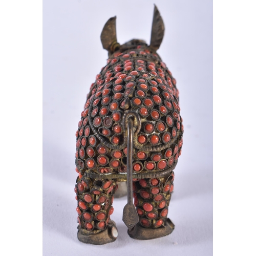 610 - AN ANTIQUE TIBETAN BRASS AND CORAL RHINOCEROS. 8 cm wide.