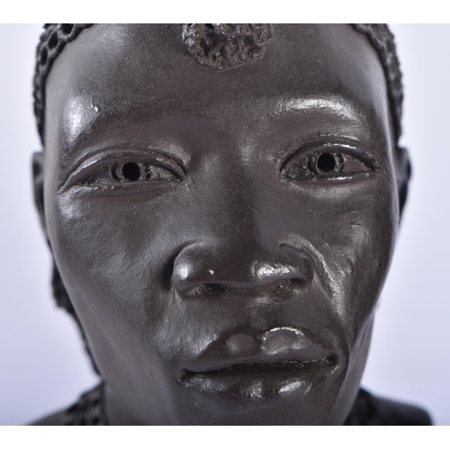 614 - A PAIR OF AFRICAN KENYAN CERAMIC BUSTS OF A MAASAI LADY AND GENTLEMAN by Apollo. 13 cm high.