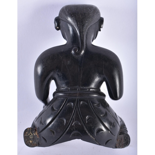 652 - AN 18TH/19TH CENTURY INDIAN CARVED EBONY FIGURE OF A SEATED MALE. 11 cm x 7.5 cm.