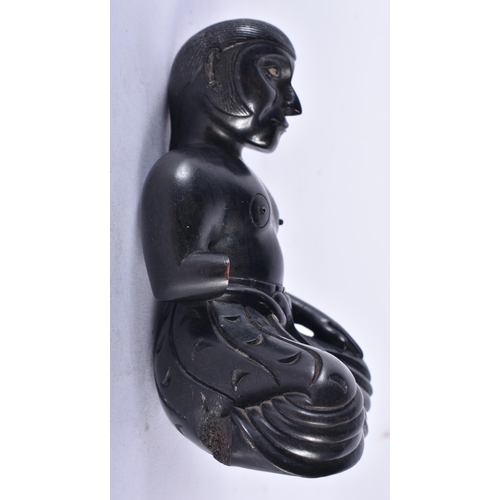 652 - AN 18TH/19TH CENTURY INDIAN CARVED EBONY FIGURE OF A SEATED MALE. 11 cm x 7.5 cm.