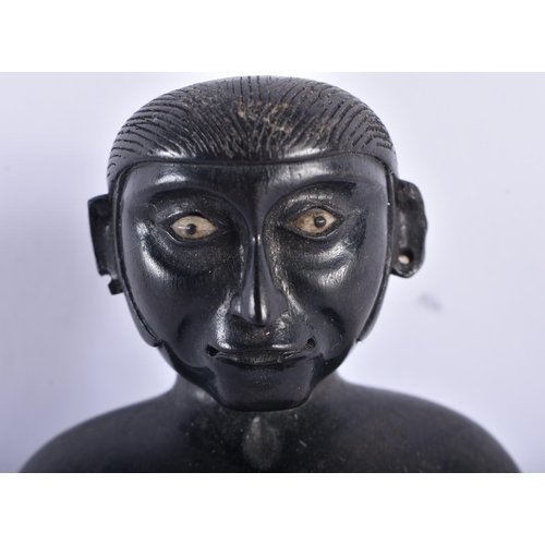 652 - AN 18TH/19TH CENTURY INDIAN CARVED EBONY FIGURE OF A SEATED MALE. 11 cm x 7.5 cm.