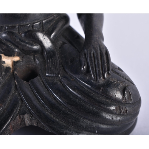 652 - AN 18TH/19TH CENTURY INDIAN CARVED EBONY FIGURE OF A SEATED MALE. 11 cm x 7.5 cm.