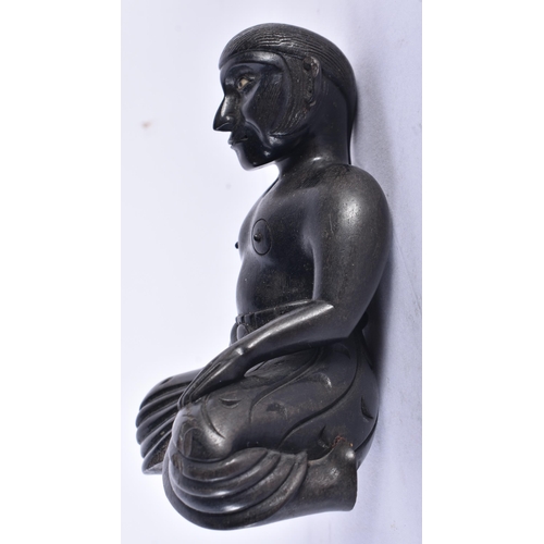 652 - AN 18TH/19TH CENTURY INDIAN CARVED EBONY FIGURE OF A SEATED MALE. 11 cm x 7.5 cm.