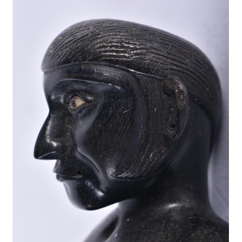 652 - AN 18TH/19TH CENTURY INDIAN CARVED EBONY FIGURE OF A SEATED MALE. 11 cm x 7.5 cm.