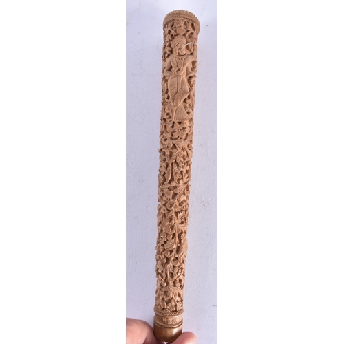 659 - A 19TH CENTURY INDIAN CARVED SANDALWOOD CANE HANDLE decorated with figures and foliage. 22 cm long.