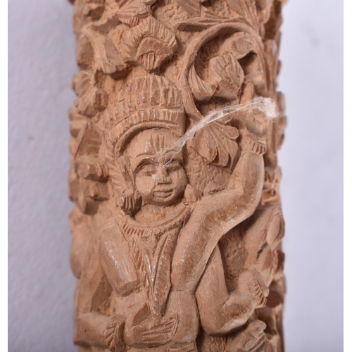 659 - A 19TH CENTURY INDIAN CARVED SANDALWOOD CANE HANDLE decorated with figures and foliage. 22 cm long.