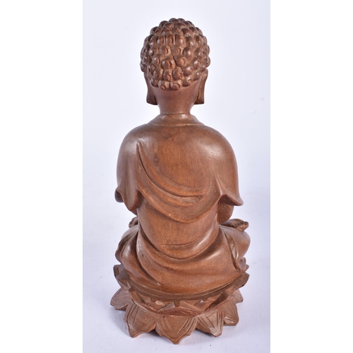 660 - A 19TH CENTURY CHINESE CARVED HARDWOOD FIGURE OF A BUDDHA together with a bamboo brush pot. Largest ... 