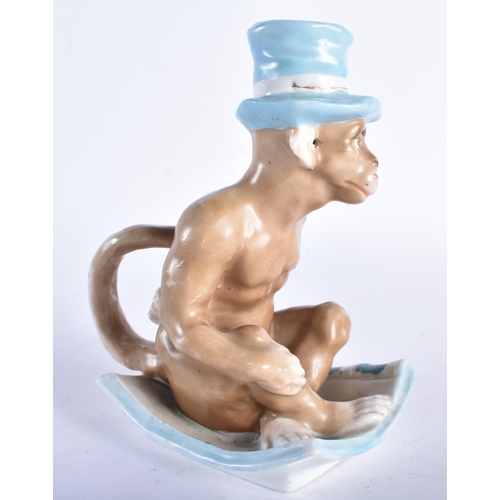 665 - A RARE 19TH CENTURY CONTINENTAL PORCELAIN CHAMBERSTICK modelled as a seated monkey wearing a top hat... 